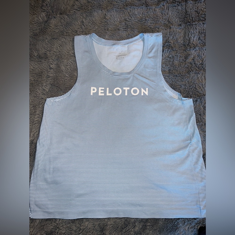 NUX size small peloton tank. Light blu striped. Wide panel on the sides.